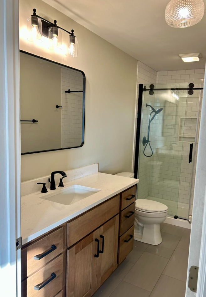 A kitchen with stainless steel appliances and white cabinets.