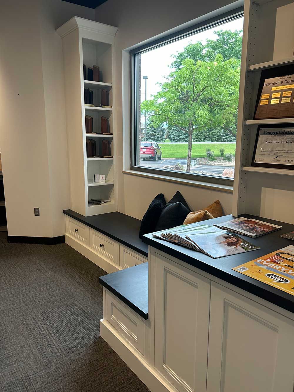 A waiting room with a window and a bench.