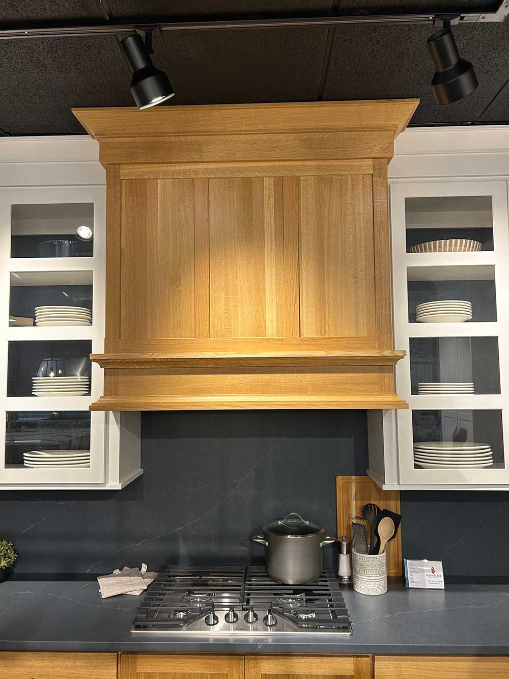 A kitchen with wooden cabinets and a stove top oven