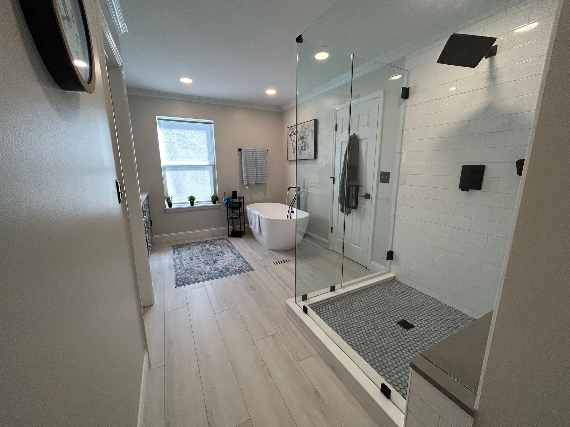 A bathroom with a tub and a walk in shower.