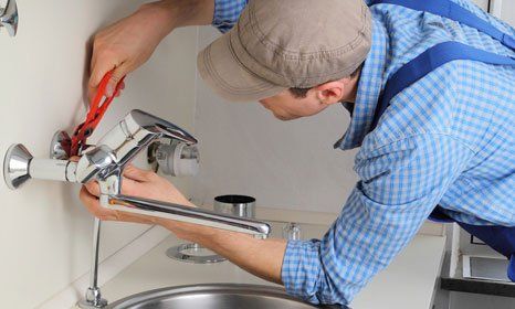 Plumber repairing the faucet