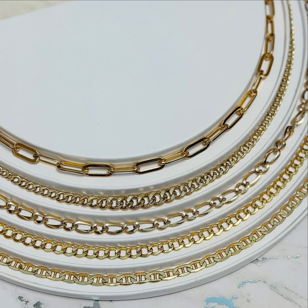 Gold necklaces displayed in a circular pattern.