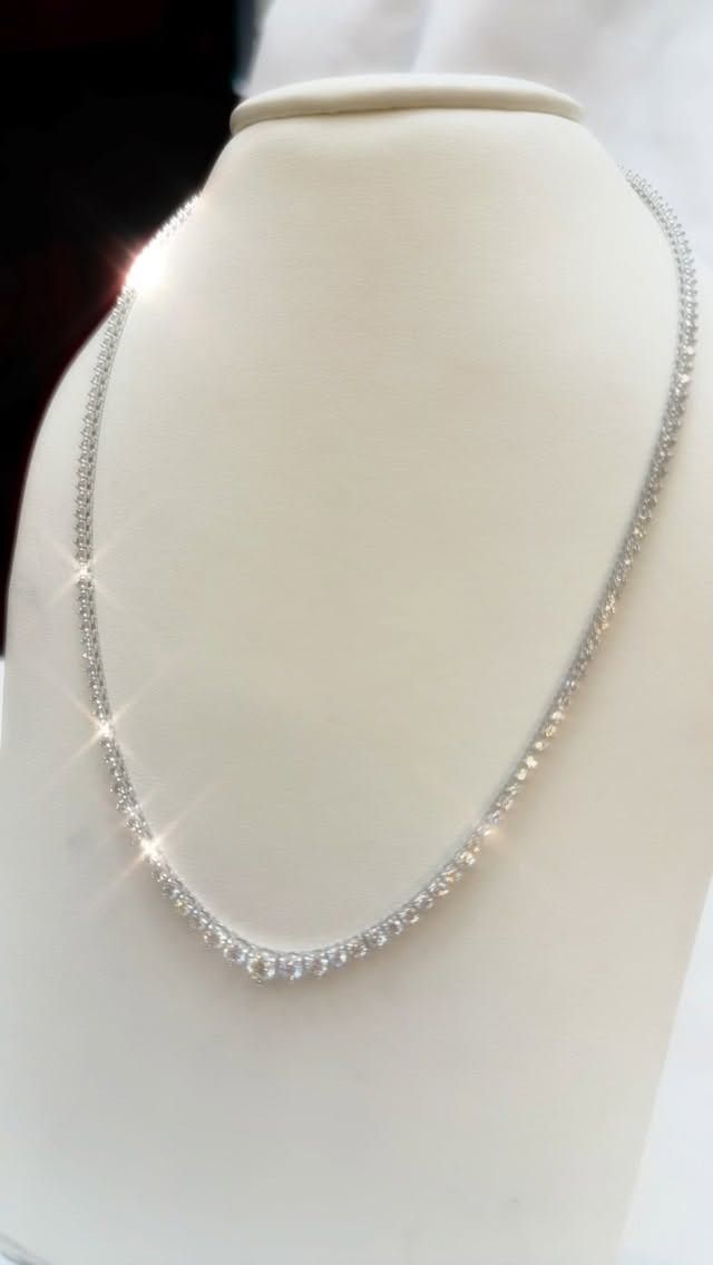 Diamond necklace displayed on a white mannequin.