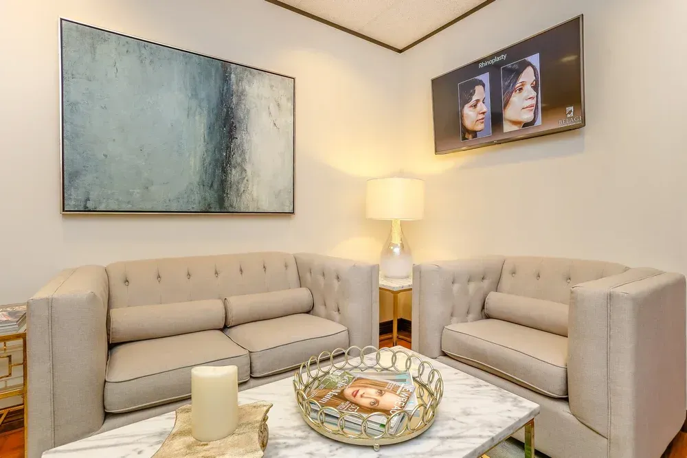 Modern living room with two beige sofas, abstract wall art, and a floor lamp between them