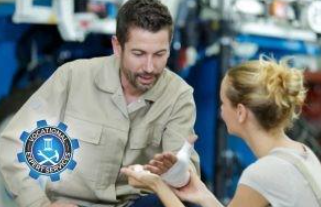 A professional applies a bandage to an injured person’s hand.