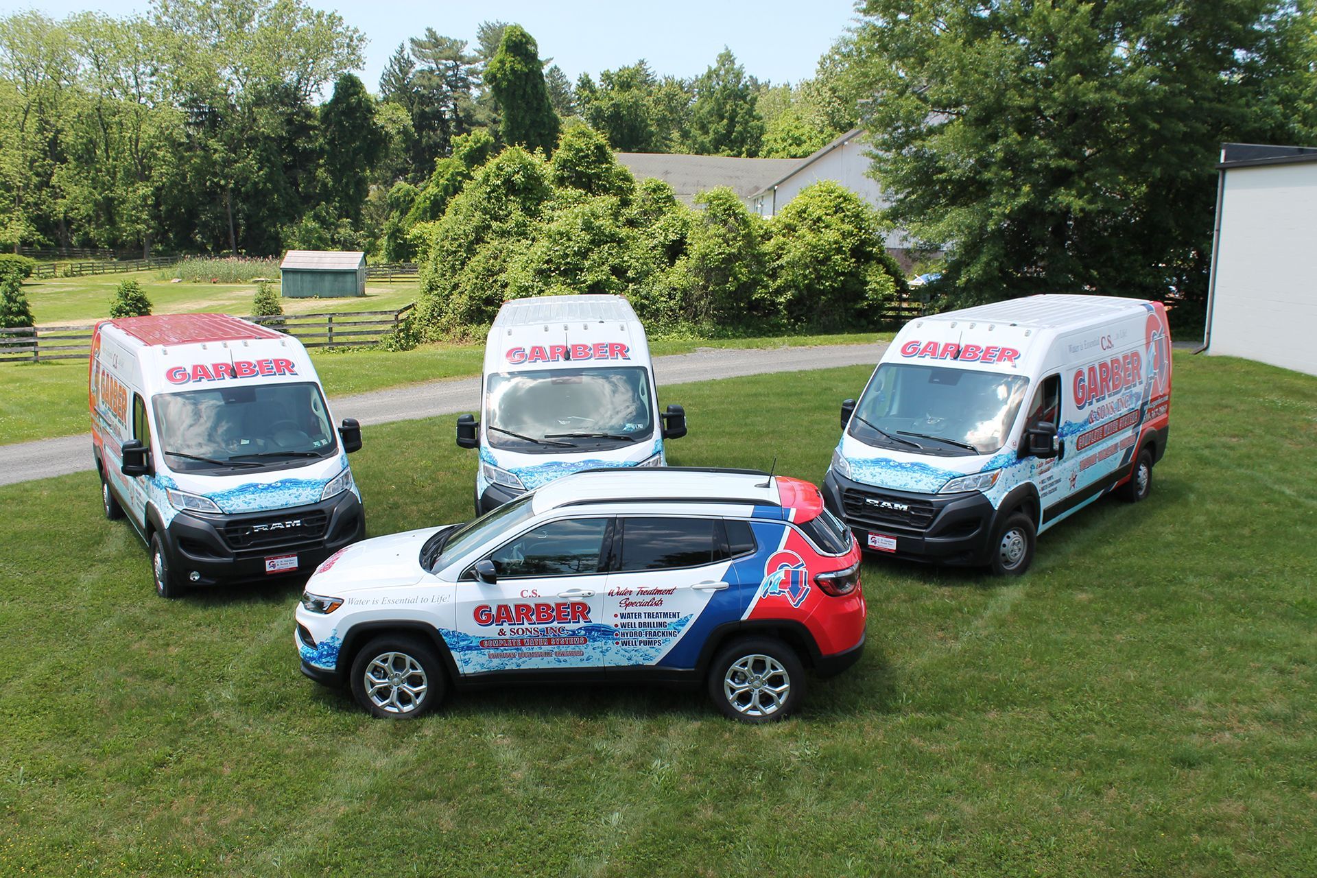 A group of Garber C S & Sons Inc cars and vans