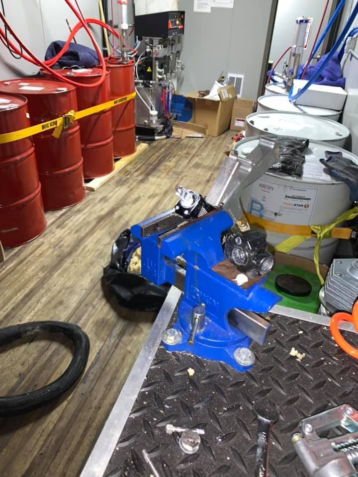 A room with a lot of barrels and tools on the floor