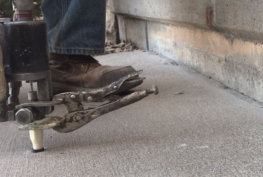 A close up of a person 's foot with a pair of pliers on it