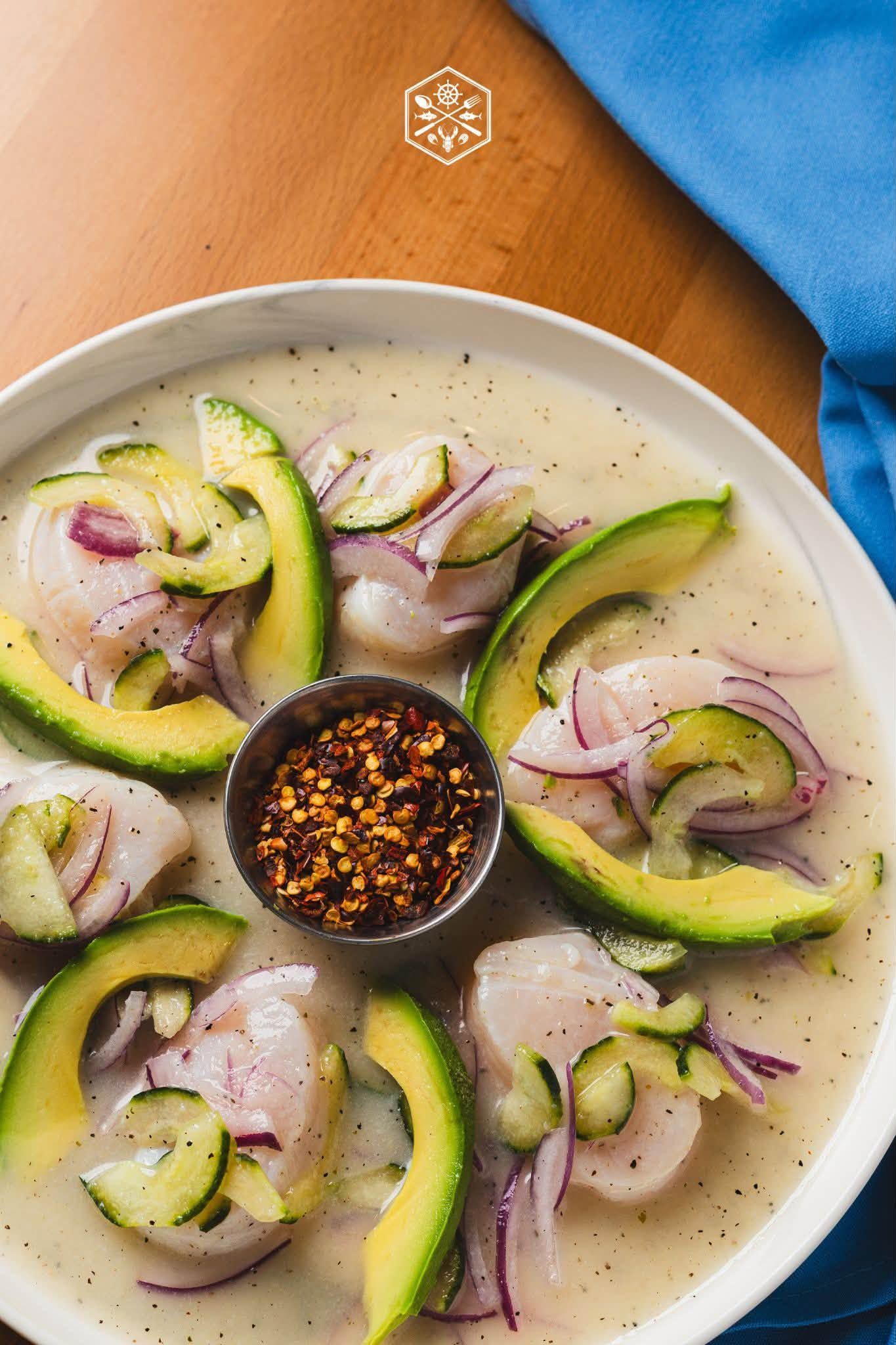 Creamy cucumber and red onion salad with chili flakes in a bowl