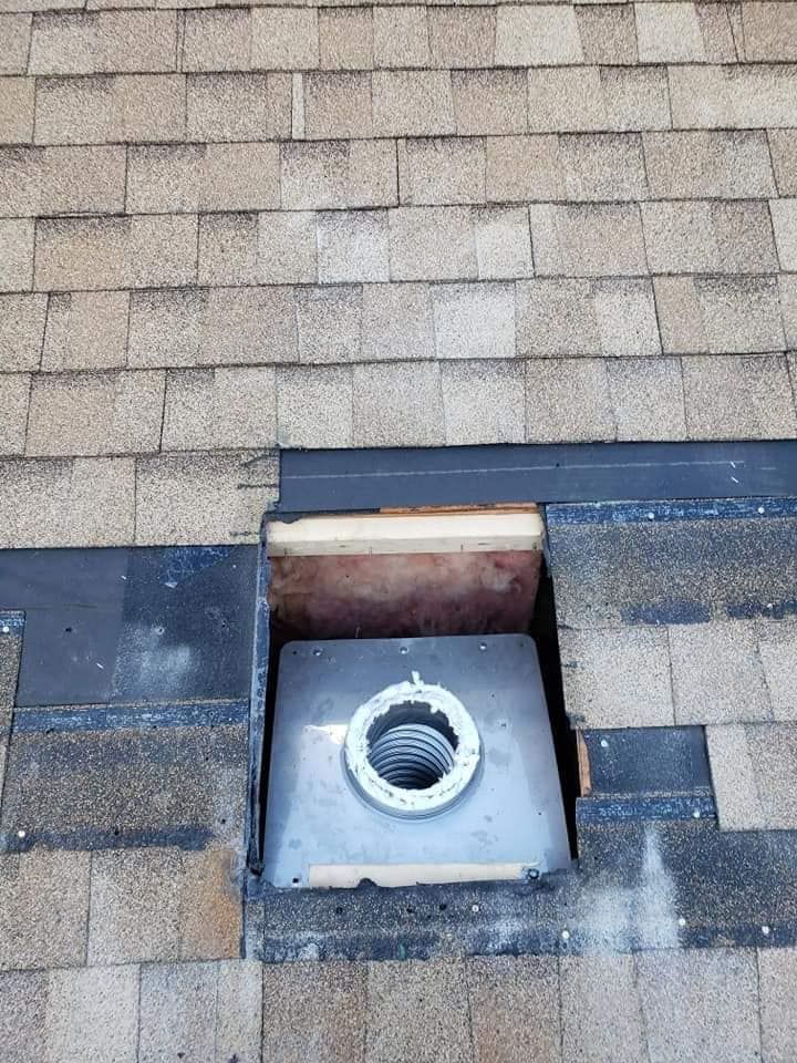 A roof with a hole in it that looks like a chimney