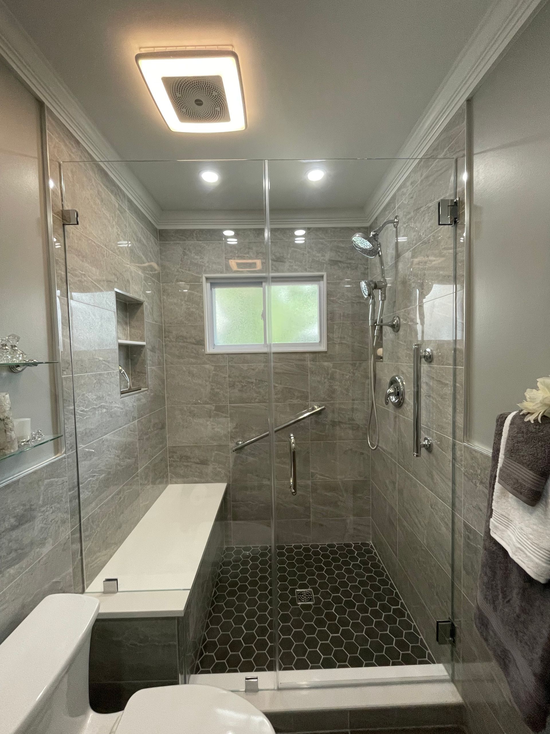A bathroom with a walk in shower and a toilet