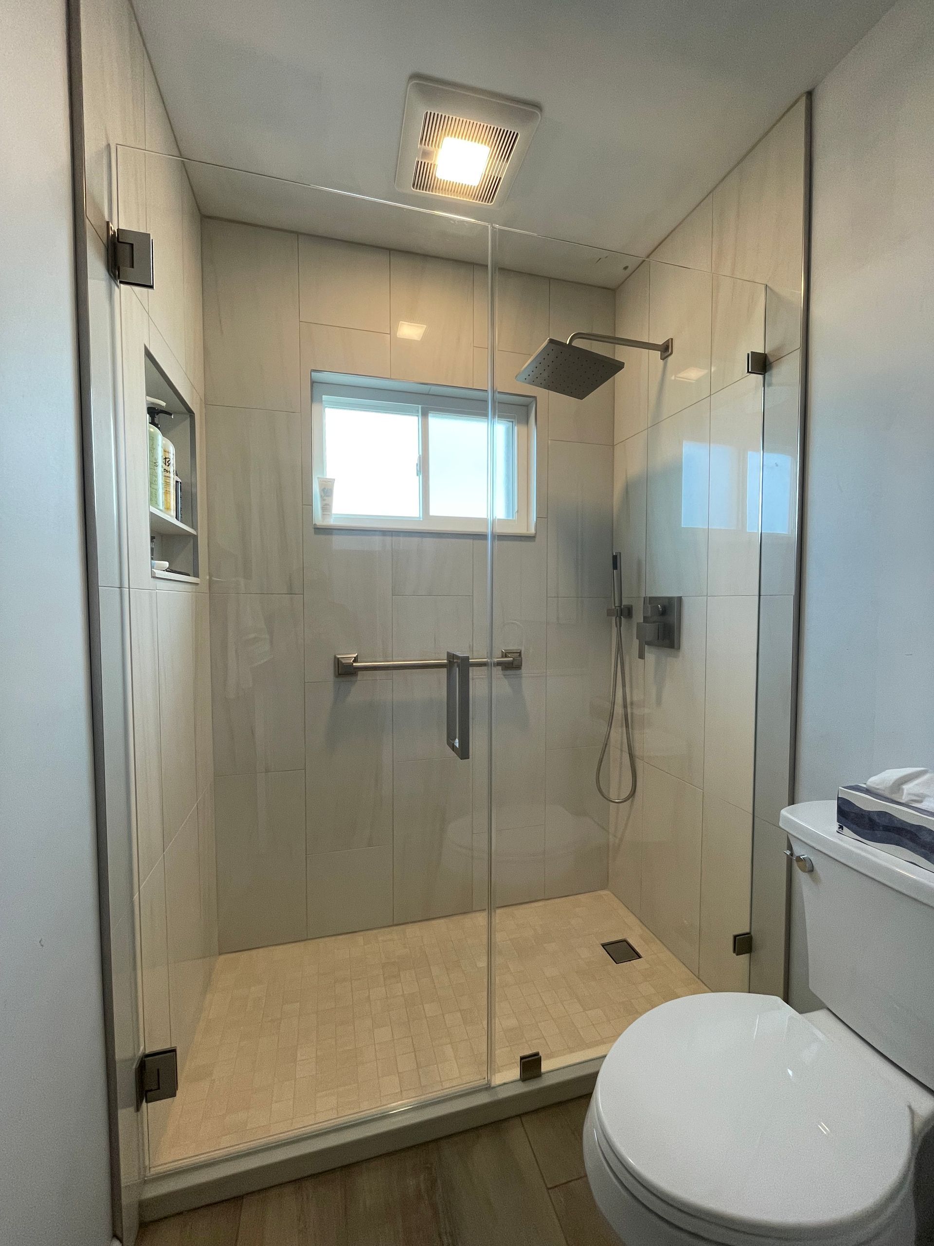 A bathroom with a walk in shower and a toilet