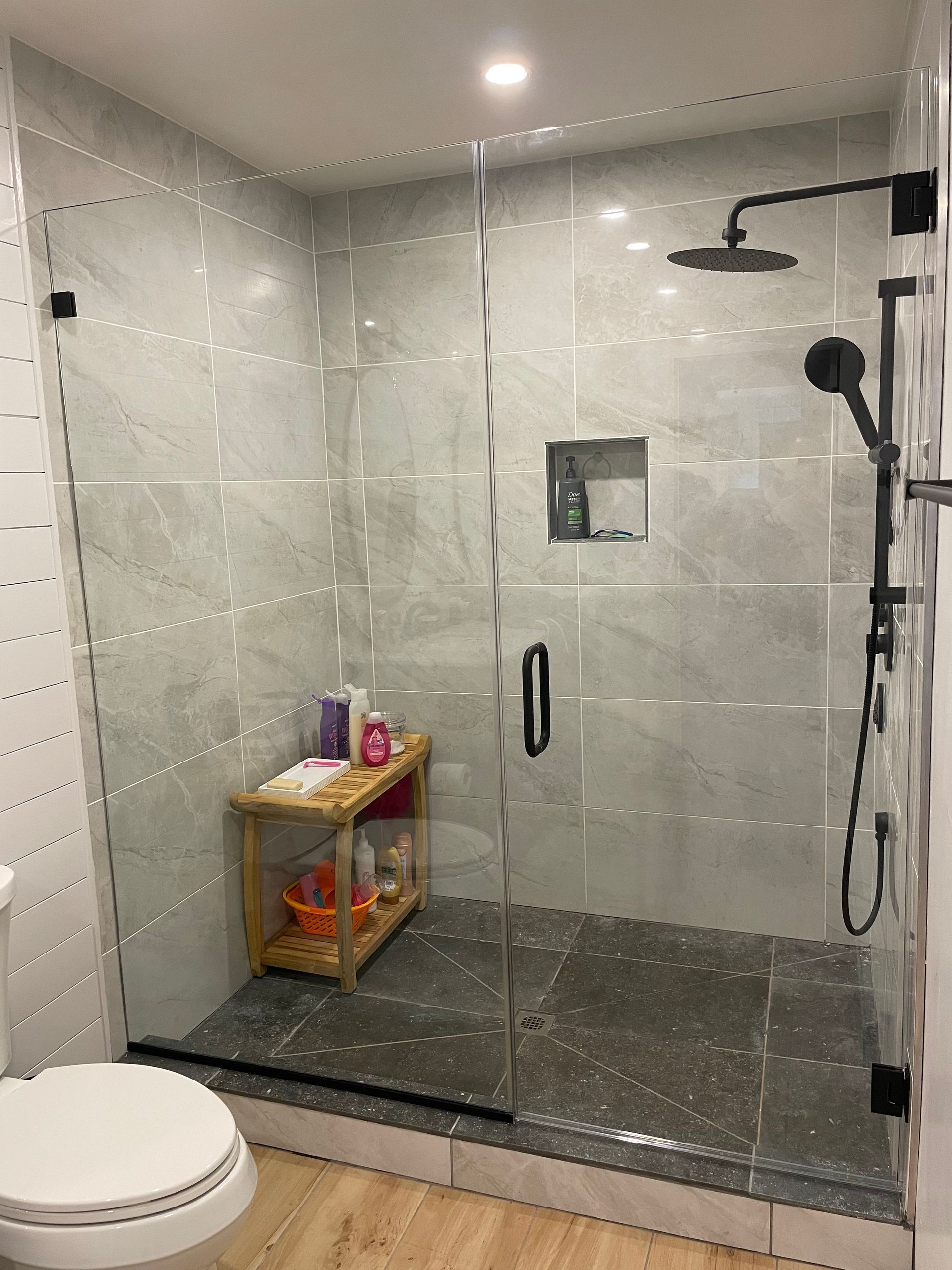 A bathroom with a walk in shower and a toilet.