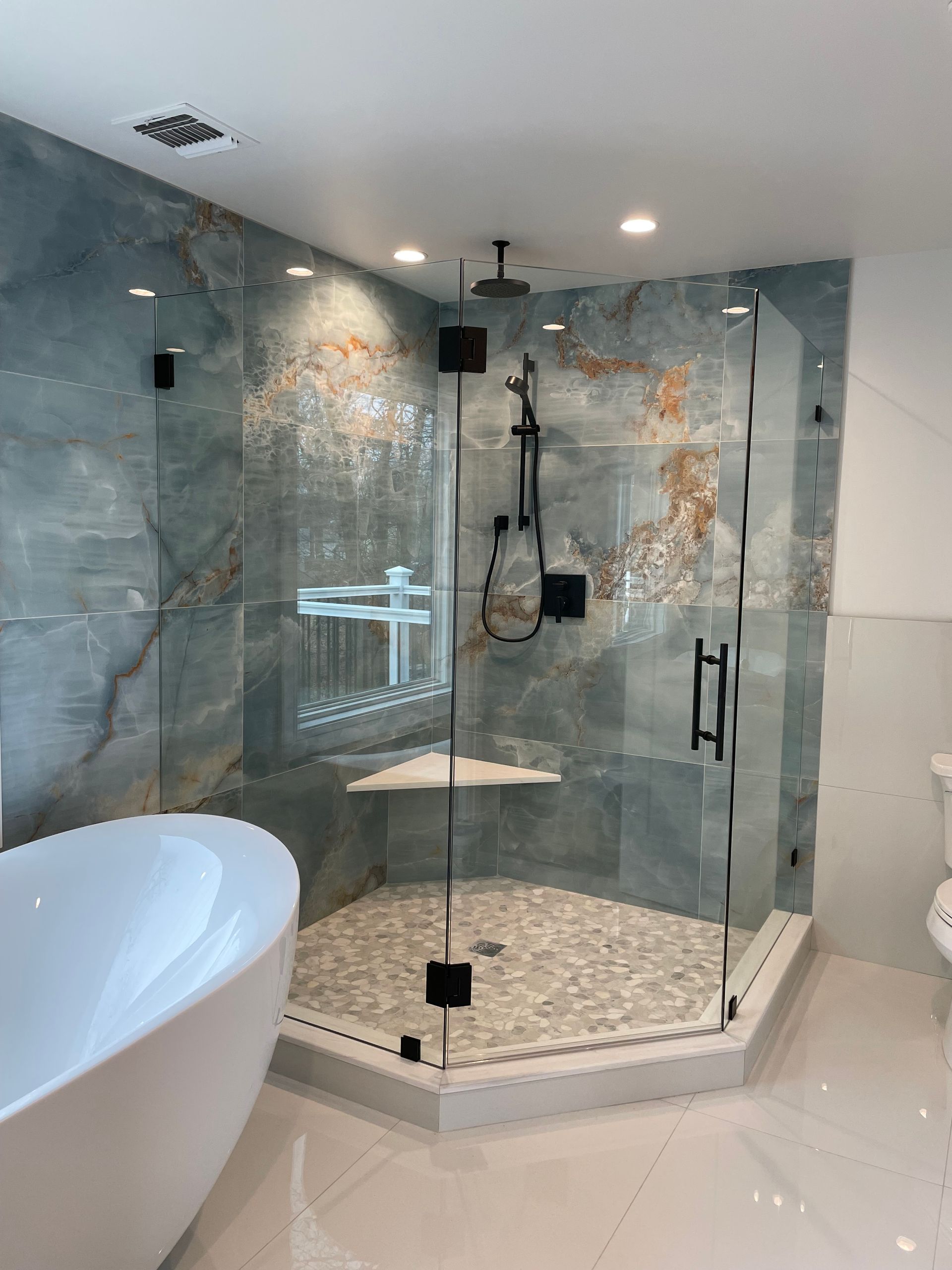 A bathroom with a walk in shower and a bathtub.