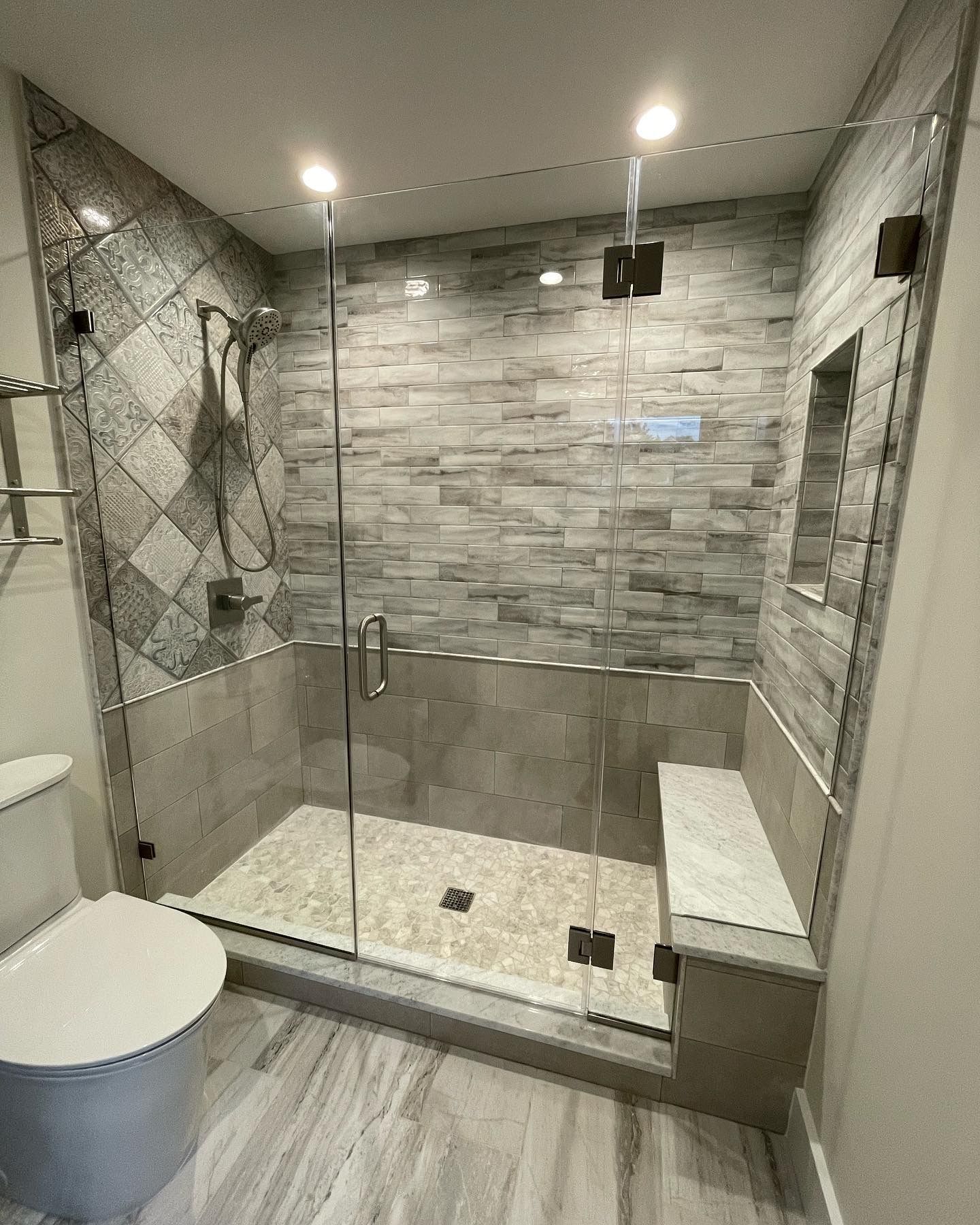 A bathroom with a walk in shower and a toilet.