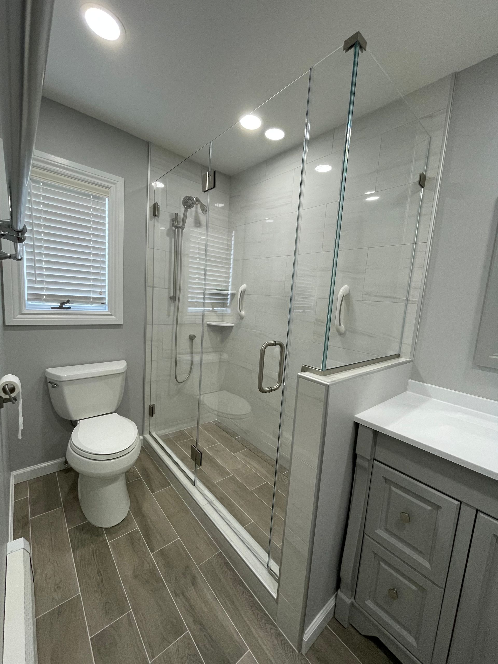 A bathroom with a toilet , sink , and shower.