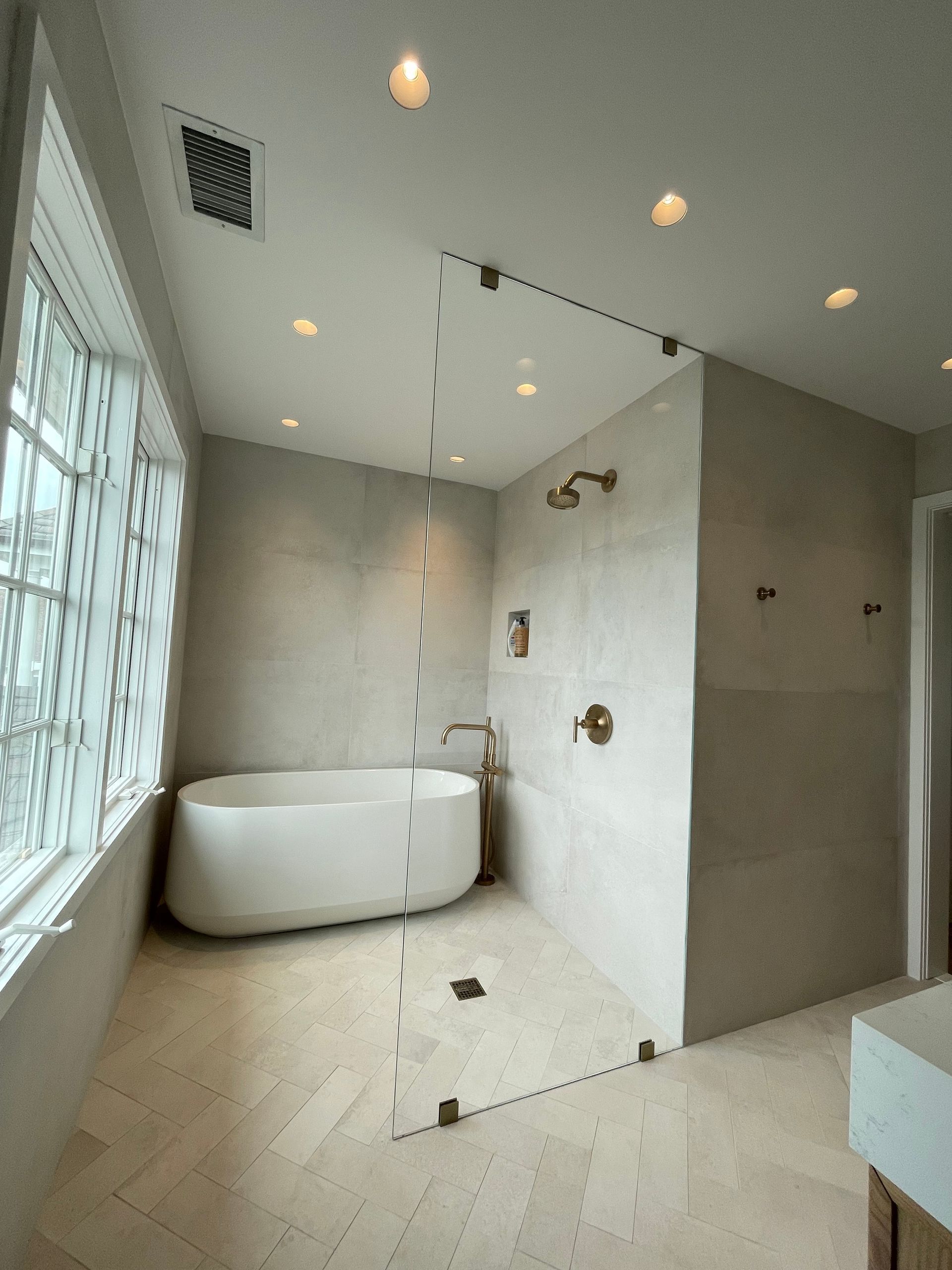 A bathroom with a bathtub and a walk in shower.