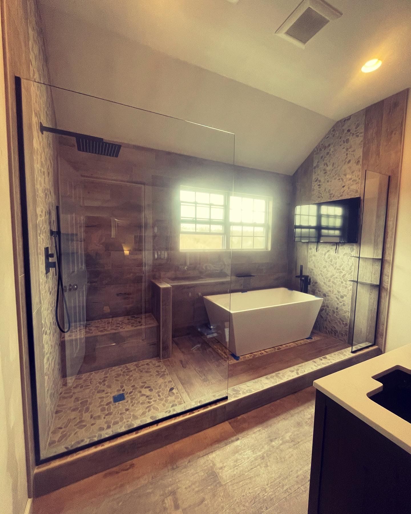 A bathroom with a walk in shower and a bathtub