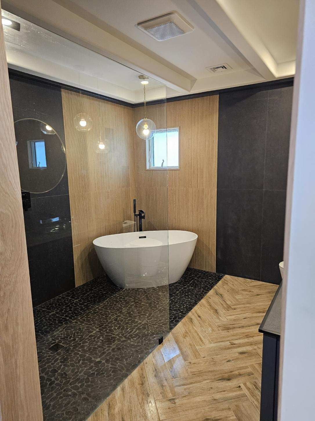 A bathroom with a bathtub and a walk in shower.