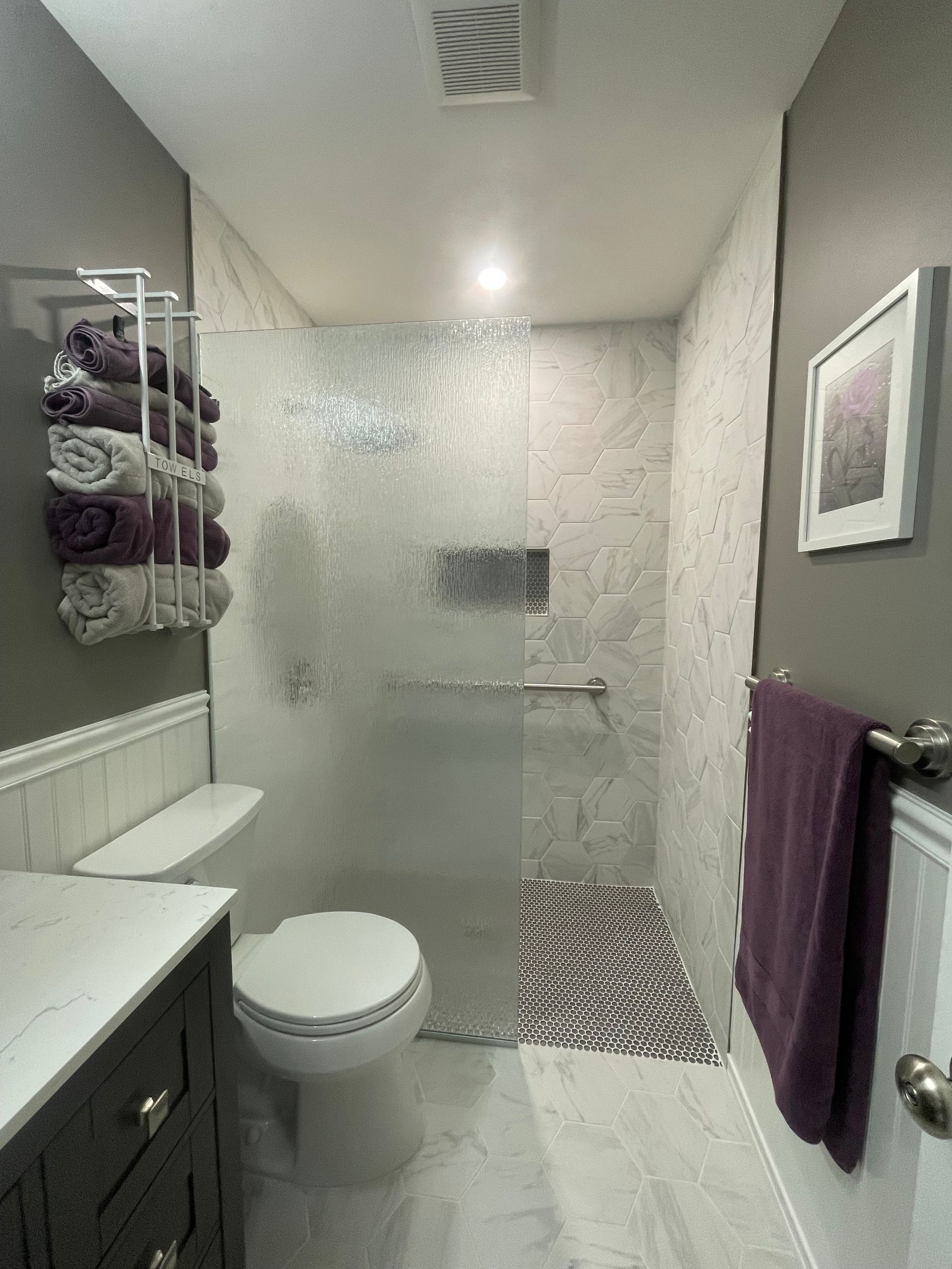 A bathroom with a toilet , sink , and shower.