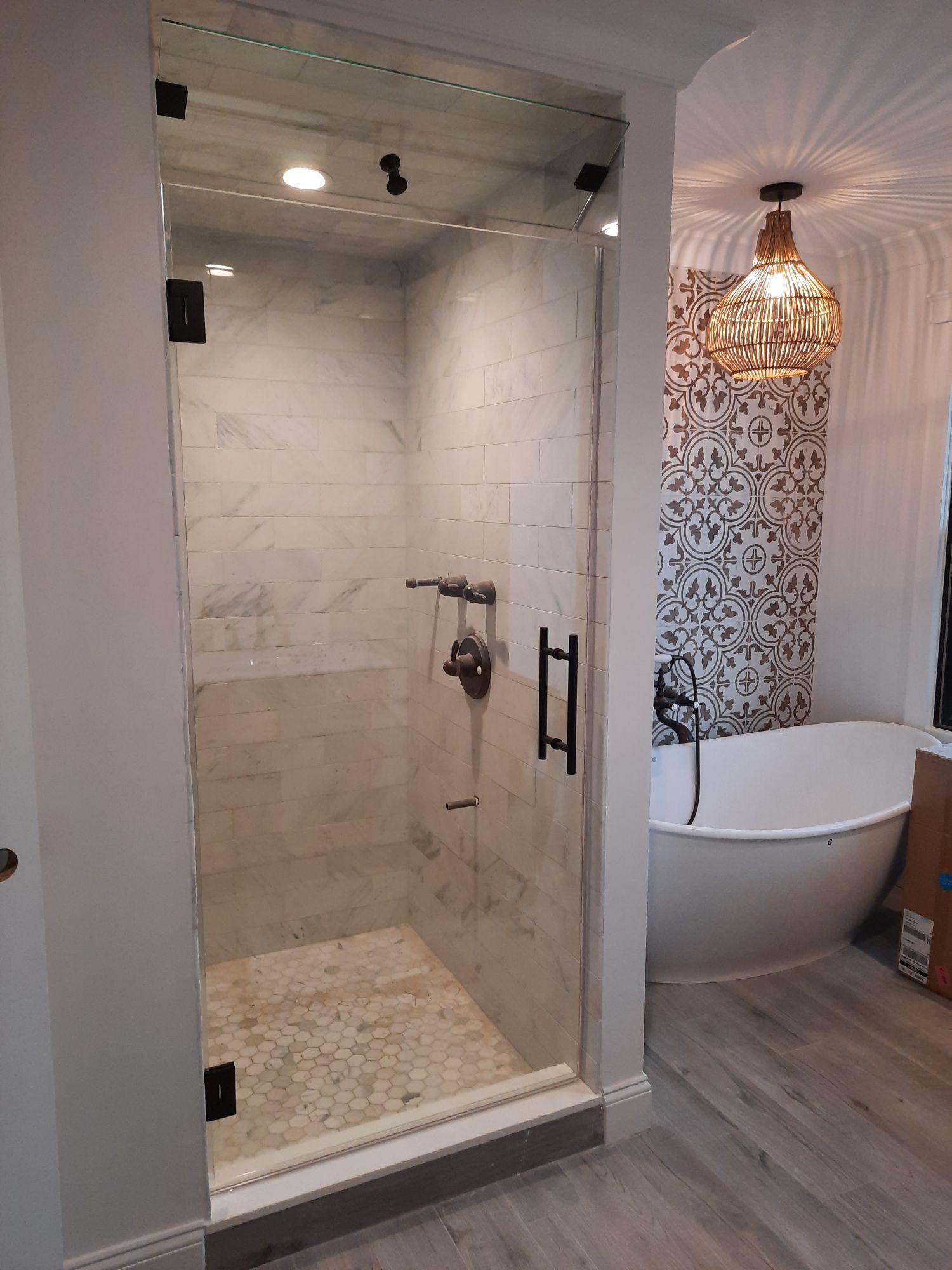 A bathroom with a walk in shower and a bathtub.