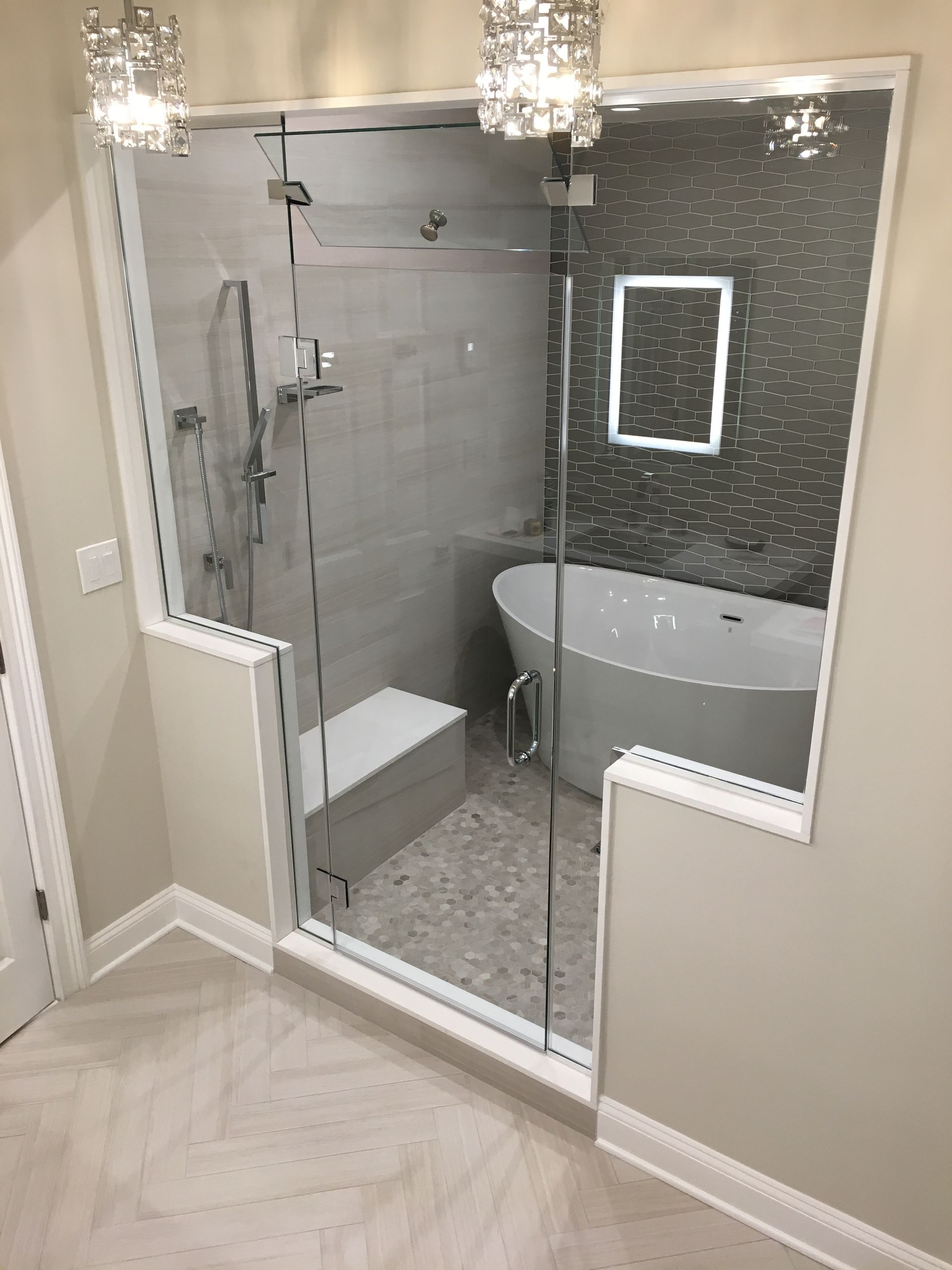 A bathroom with a bathtub , shower , and mirror.
