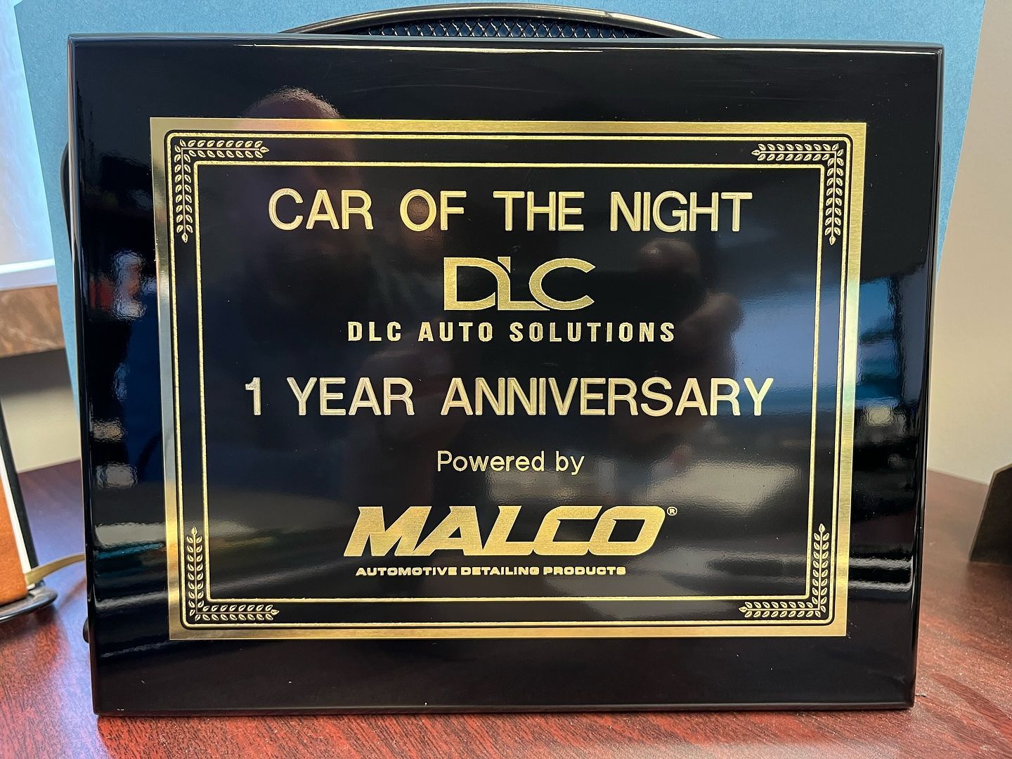 Black plaque with gold lettering. 