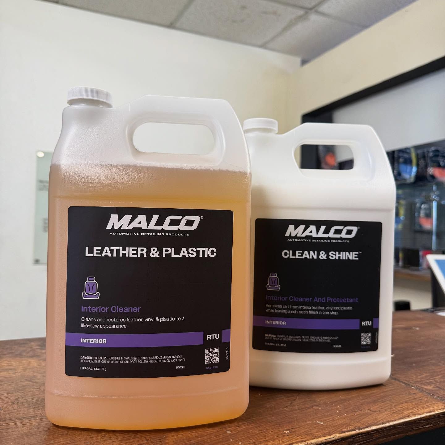 Two MALCO cleaner bottles on a counter, labeled 