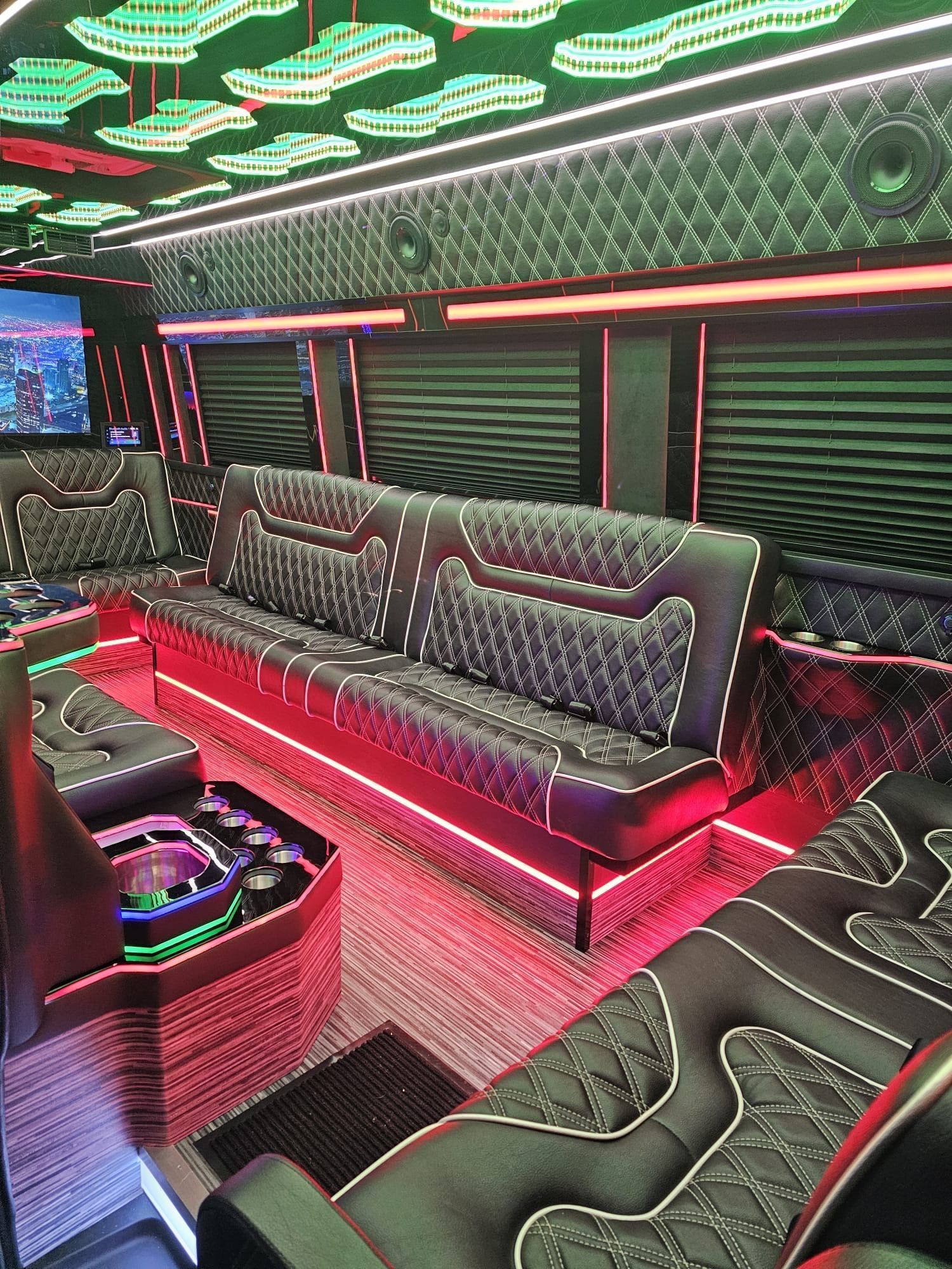 Neon-lit lounge with patterned sofas, red LED accents, and green ceiling lights.