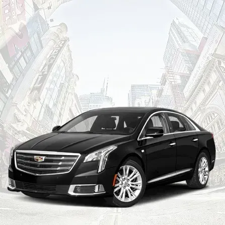 Black Cadillac sedan on a bright studio-style background with faint city buildings