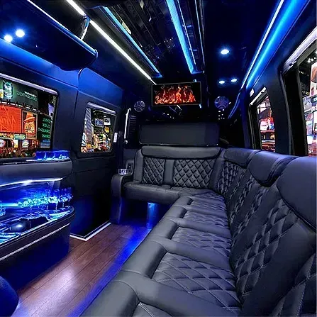Blue-lit luxury limousine interior with quilted black leather seats and overhead LED lighting.