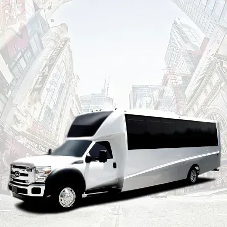 White limousine bus on a city street with tall buildings in the background