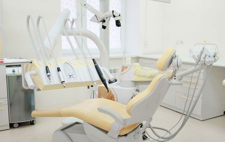 An empty dental chair in a dental office.