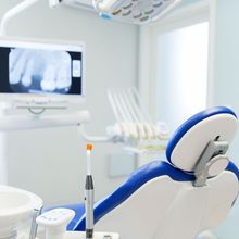 A blue and white dental chair in a dental office