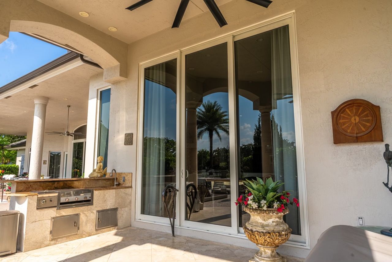 A patio with a sliding glass door and a ceiling fan.