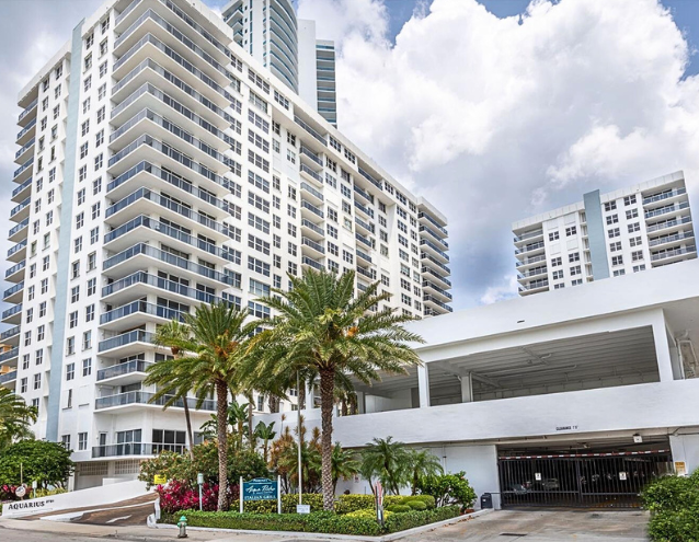 A large white building with palm trees in front of it