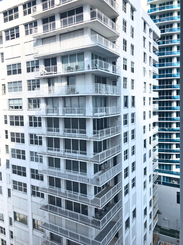 A tall building with a lot of windows and balconies.