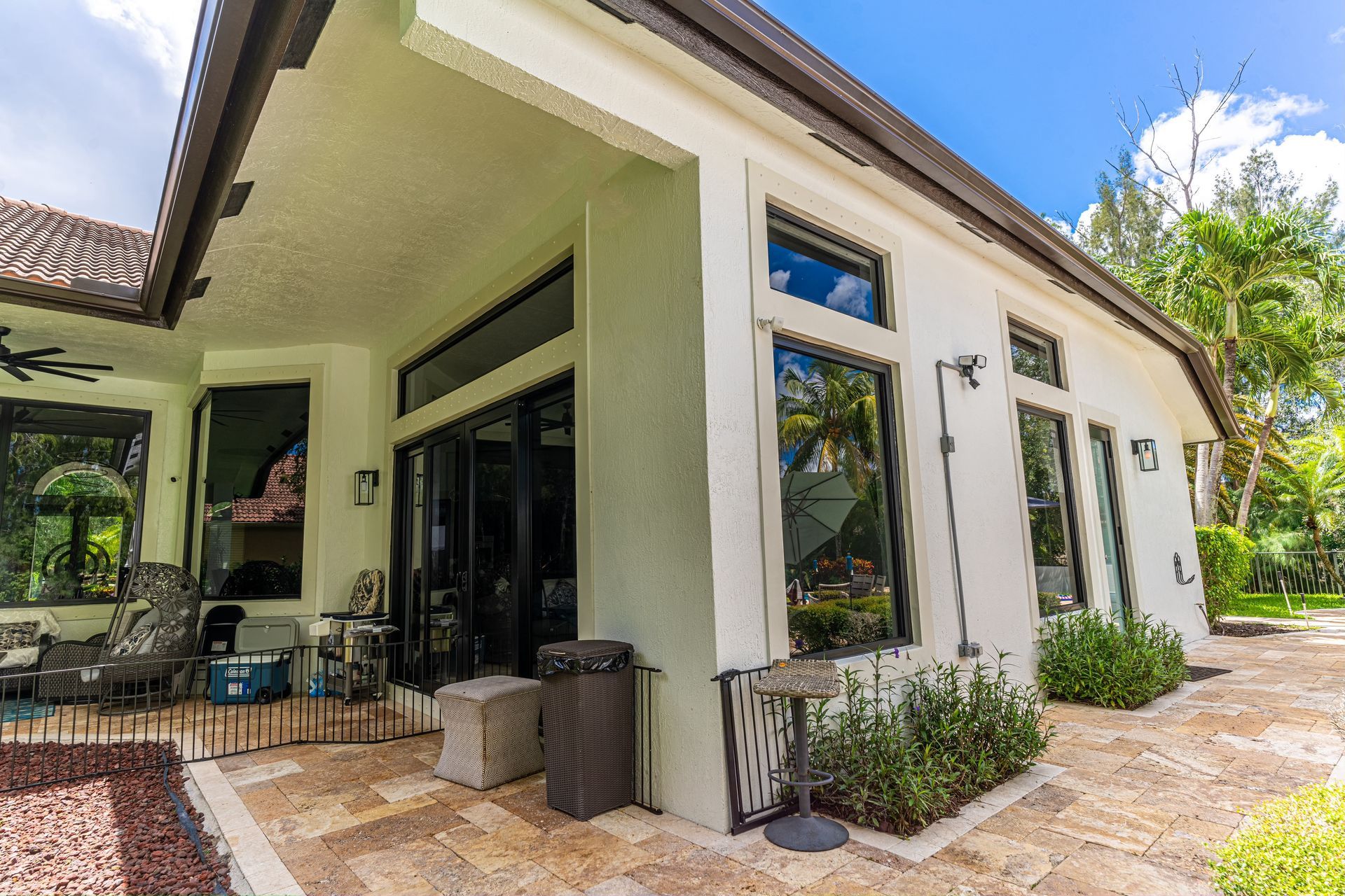 A large white house with a lot of windows and a patio.