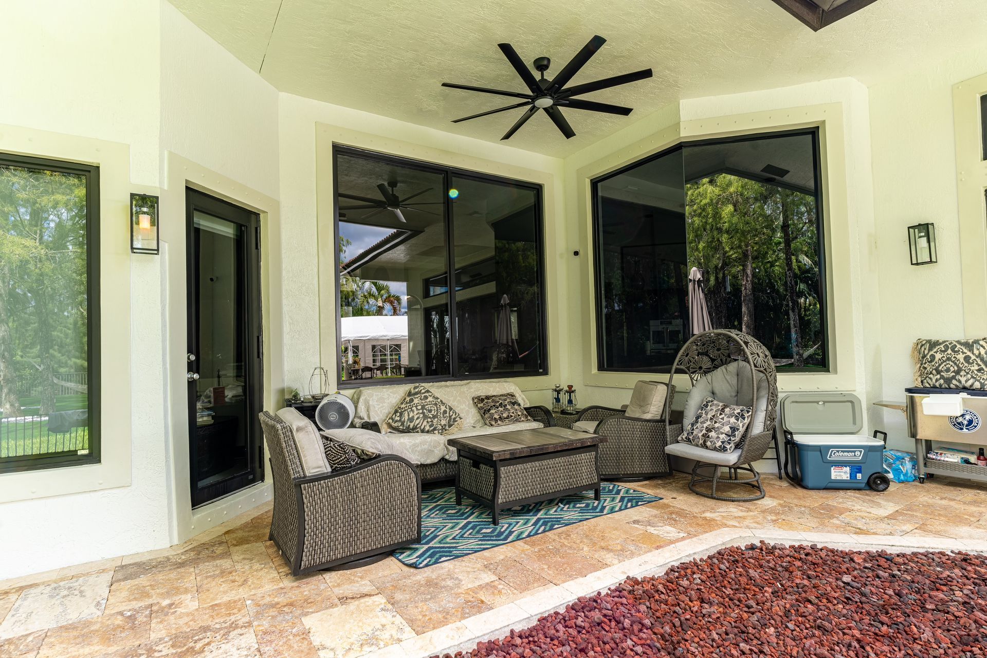 A living room with a lot of furniture and a ceiling fan.