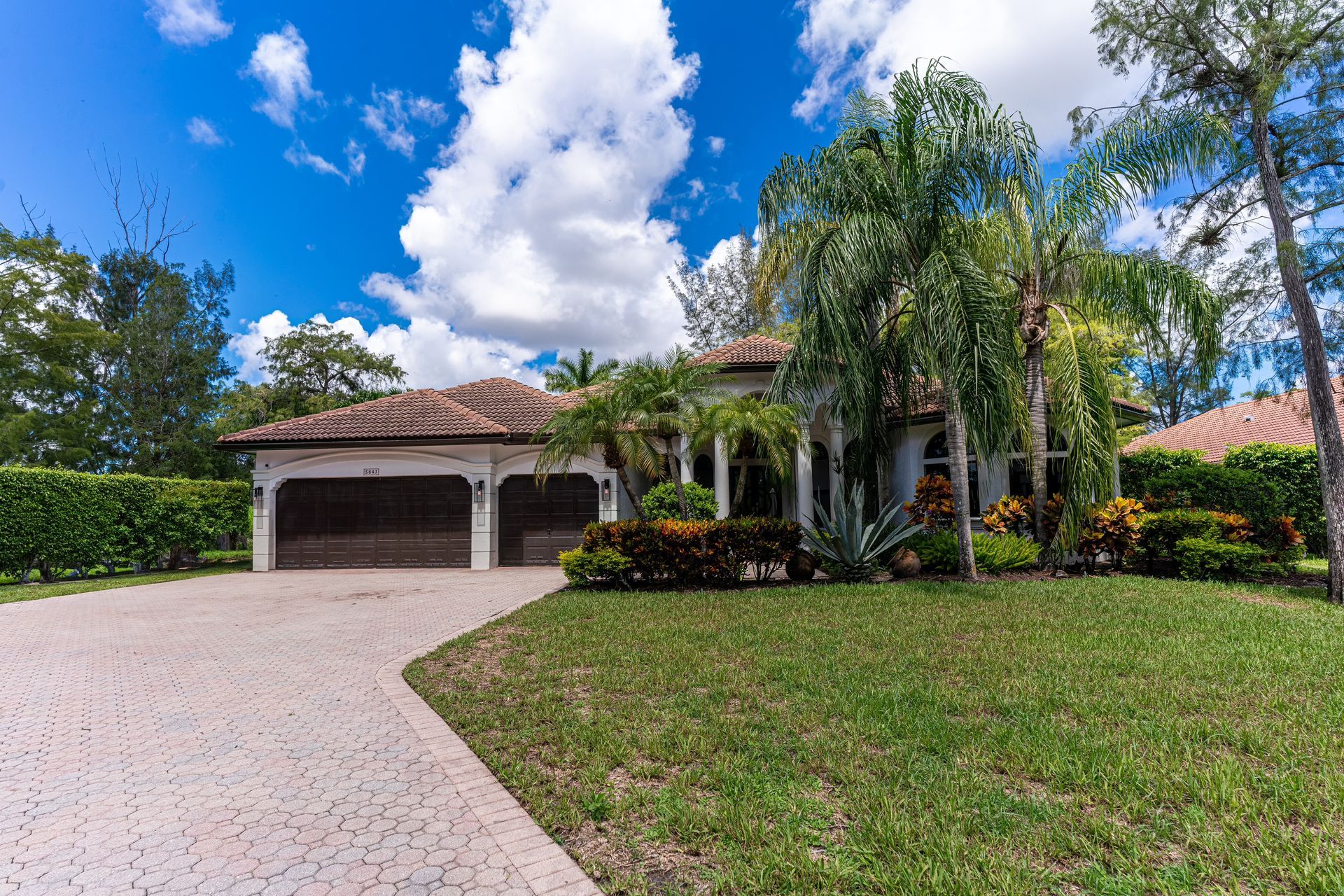 A large house with a driveway leading to it and a garage.