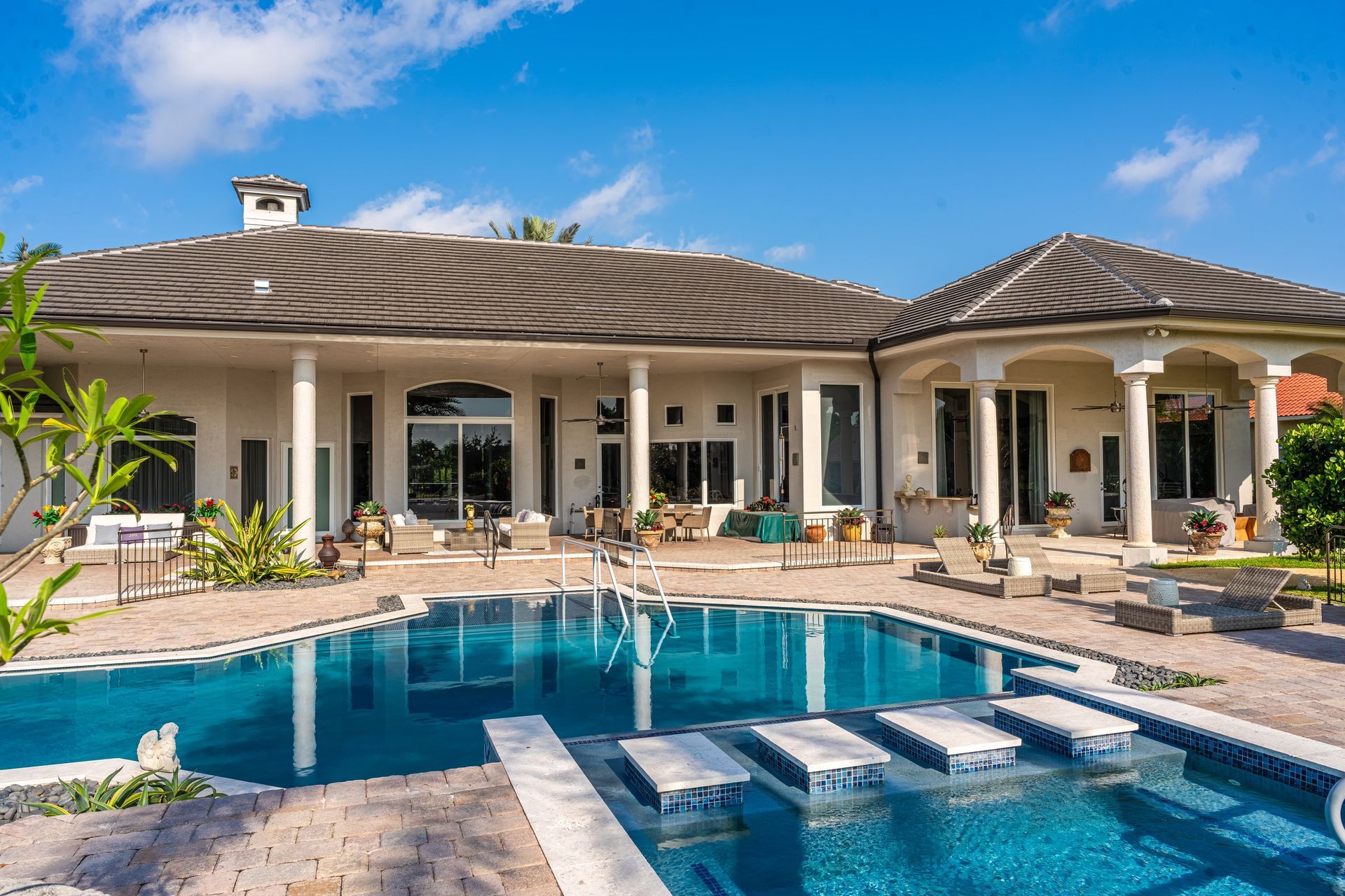 A large house with a large swimming pool in front of it.