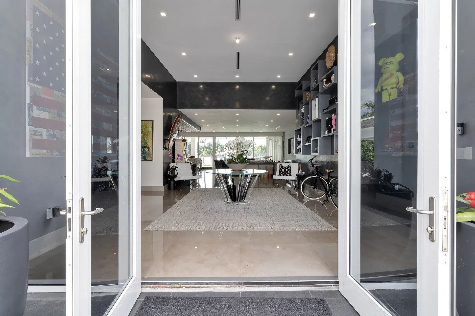 A view of a living room through a set of glass doors.