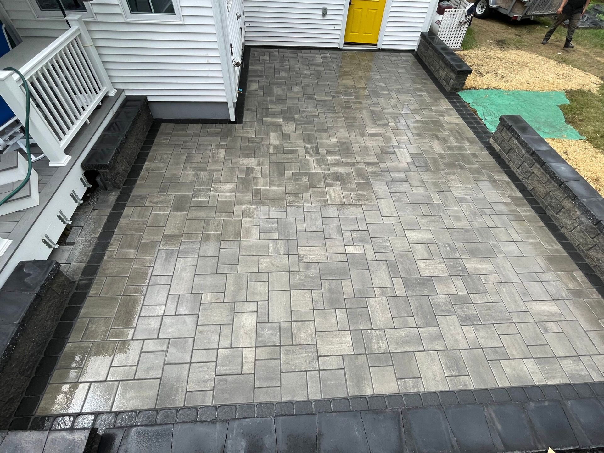 An aerial view of a brick patio in front of a house.
