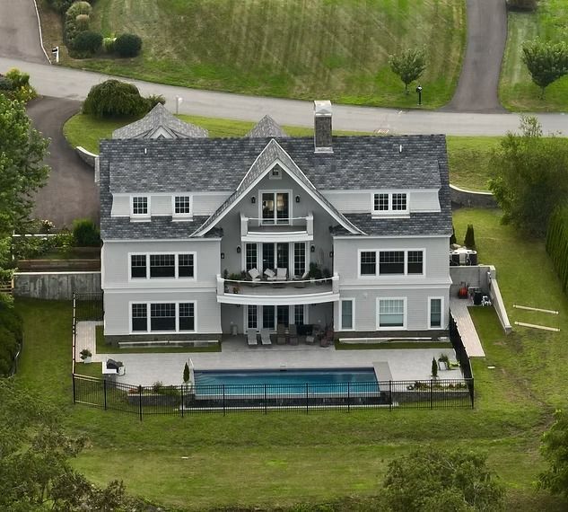 An aerial view of a large house with a swimming pool