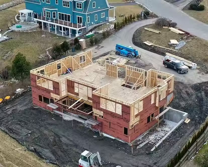 An aerial view of a building under construction in a residential area.