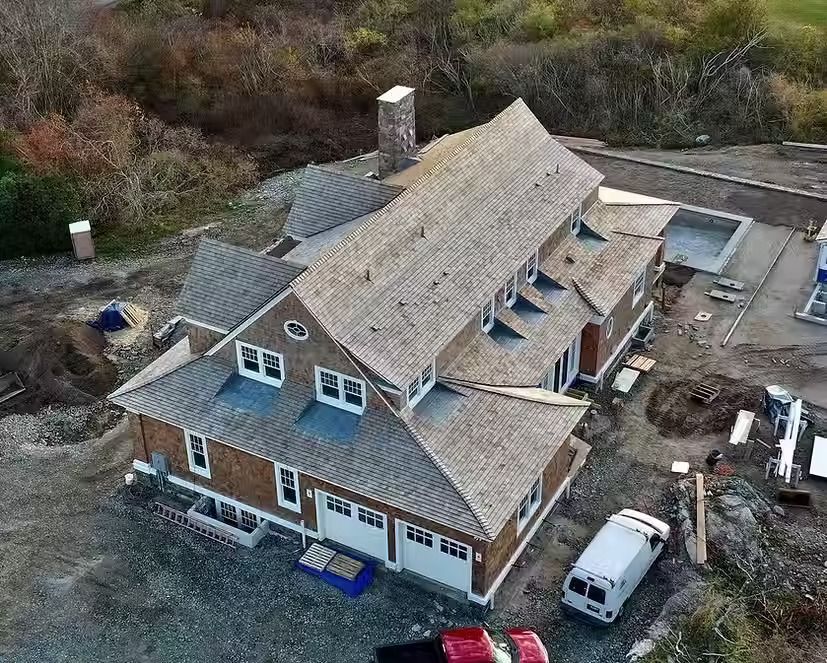 An aerial view of a large house under construction.