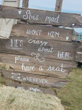 Rustic wooden sign with white text: 