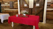 Red-covered table with floral arrangement, 