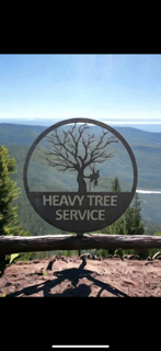 A sign that says heavy tree service on it
