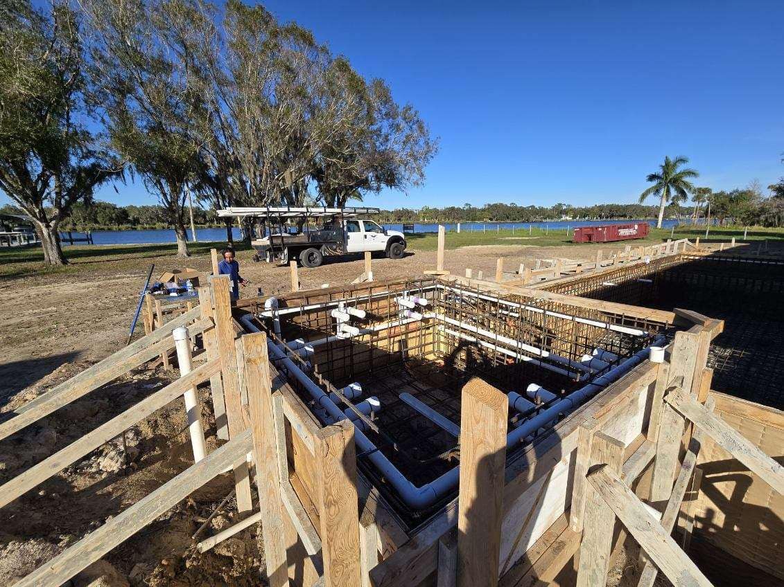 A construction site with a truck parked in the background.